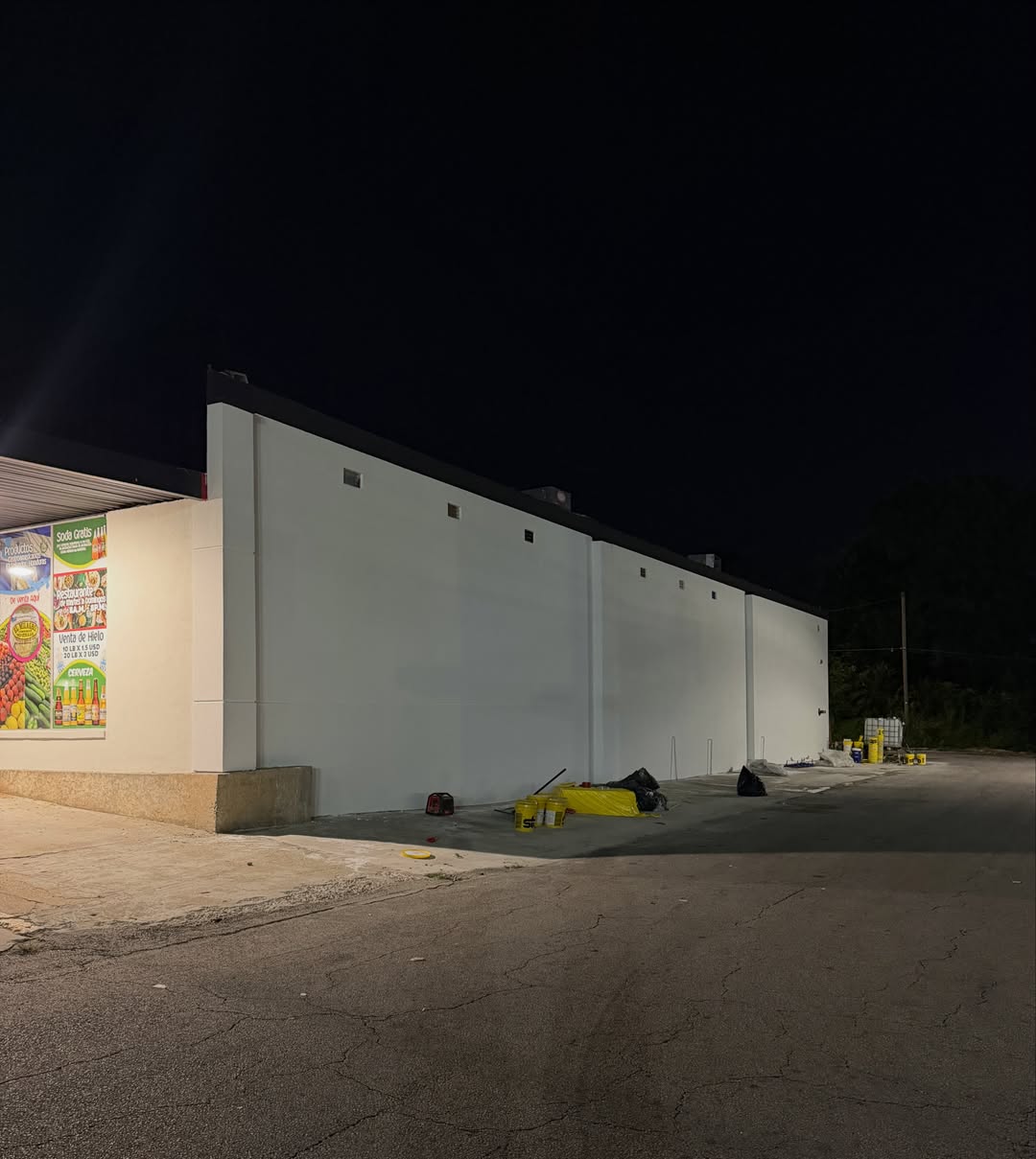 Finished white stucco commercial building at night