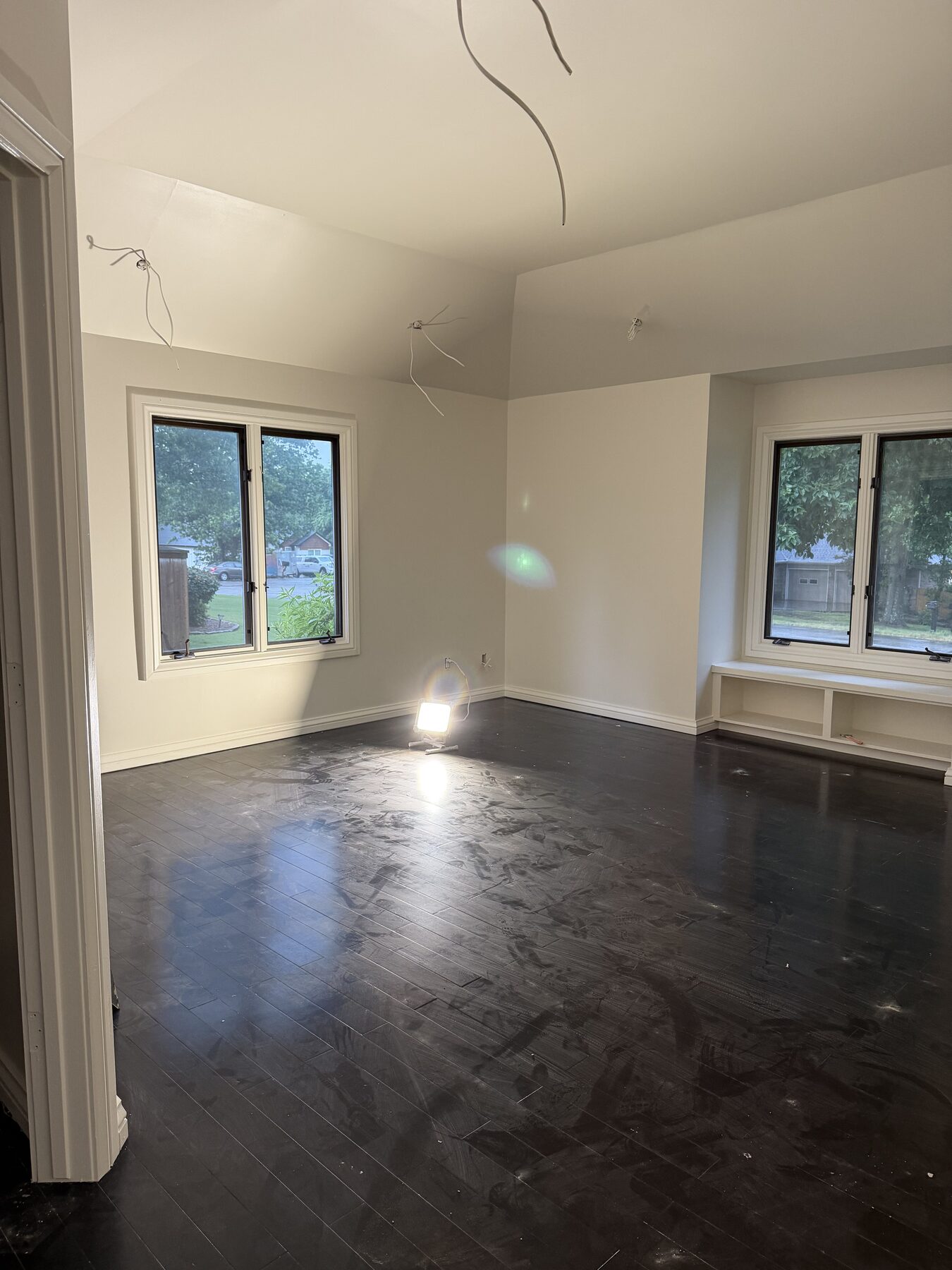 Newly painted interior with windows and dark hardwood floors